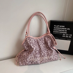 Close-up of pink leopard print canvas tote bag with white embroidery and drawstring detail