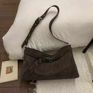 Detail view of the vintage dark brown tote with adjustable buckle strap and matte leather