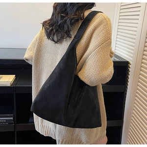 Black leather tote bag back view showing large capacity and soft minimalist design