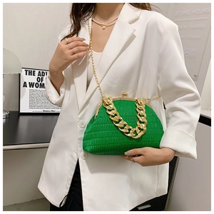 Close-up of bright green pleated shell bag with thick gold chain and vintage metal clasp