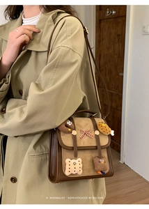 Detail of retro color-block handbag with cartoon plush patches and a decorative bow