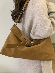 Brown suede large tote bag with buckle strap detail worn by model in beige knitwear