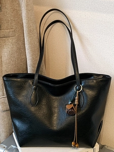 Vintage large black tote bag in glossy faux leather with a floral charm and long straps