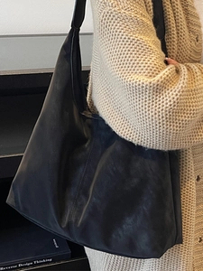 Minimalist large black matte leather hobo tote bag for women with wide shoulder strap