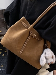 Vintage brown suede tote bag with white stitching and plush rabbit charm for women