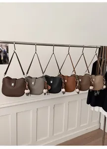Detail view of multi-color retro shoulder bags with metal locks and fabric charms