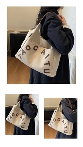 Detail of canvas tote bag showing interior storage space and exterior slip pocket design