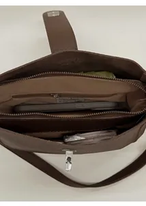 Top-down view of a brown vintage bucket bag showing organized internal storage space
