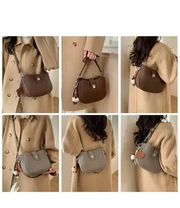 Detail view of retro bucket bags in dark brown and khaki with decorative heart charms