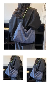 Detail of navy checkered crossbody bag with adjustable drawstring and braided strap