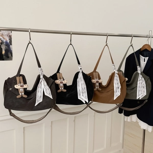 Detail of bohemian tote bags in coffee, black, caramel and green with silk scarves