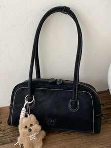 Black bowling bag in matte finish with white contrast stitching and puppy pendant