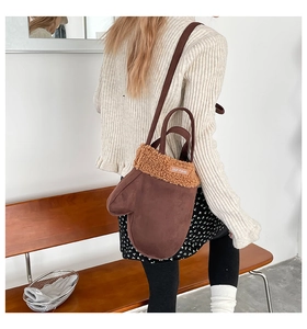 Détail du sac à bandoulière en daim en forme de gant avec bordure en laine d'agneau