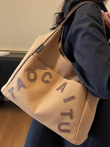 Minimalist canvas tote bag in camel brown with letter stitching for daily use