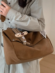 2025 Winter large brown suede tote bag with cartoon charm decoration shown on model