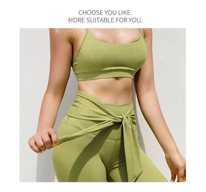 Close-up of bright green high-waisted yoga leggings with cross-tie waistband detail
