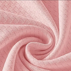 Pink waffle-knit long sleeve yoga top with UPF50+ protection and split hem detail