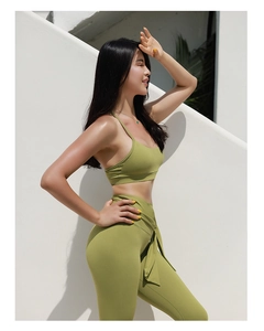 Detail of high waist avocado green yoga pants with a decorative waist tie design