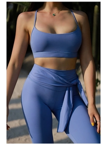 Detail view of high waist yoga pants with cross tie design in periwinkle blue fabric