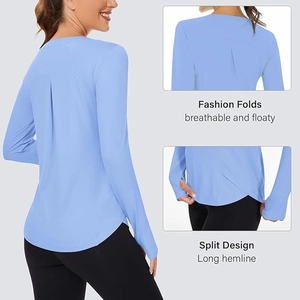 Detail of light blue yoga top with back pleats, thumbholes, and a side split design
