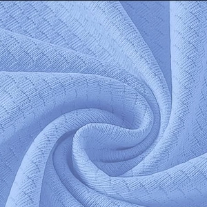 Macro shot of light blue waffle weave fabric showing breathable texture and soft drape