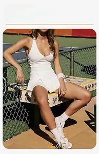Detailed view of white halter tennis dress with layered skirt and elastic athletic fabric