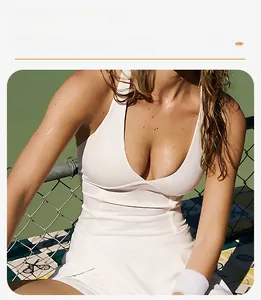Detail of white V-neck tennis dress featuring built-in chest pads for outdoor fitness