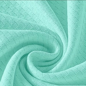 Close-up of mint green waffle knit fabric with waffle texture for yoga sports shirts