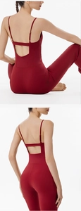 Detail of burgundy backless yoga jumpsuit featuring thin straps and crisscross cut-out design