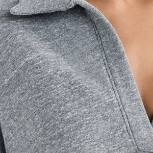 Close-up of heather grey knitted V-neck top showing soft texture and fine fabric detail