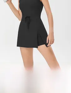 Detail view of black tennis dress featuring drawstring waist and side slit with inner shorts