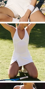 Detail of white V-neck tennis dress showing crossover straps and slit skirt with inner shorts