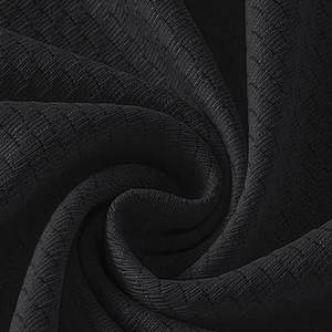 Close-up of black waffle knit fabric showing premium texture and breathable mesh pattern
