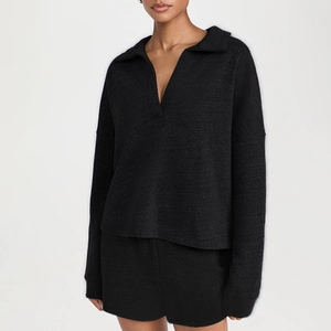 Detail view of the soft knitted texture on the dark grey V-neck long sleeve and shorts set