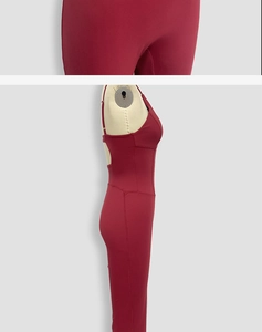 Detail view of burgundy backless yoga jumpsuit featuring thin straps and elastic fabric