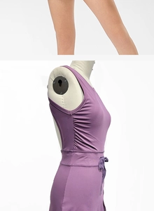 Detail view of the purple tennis dress featuring side drawstring ruching and high-stretch fabric