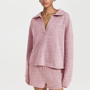 Close-up of heather pink V-neck sweatshirt and shorts set showing soft knit texture