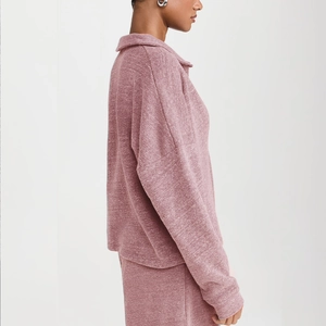 Detail of dusty rose waffle knit texture on loose V-neck polo collar tracksuit set