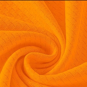 Macro shot of bright orange ribbed knit fabric texture showing vertical stripe patterns