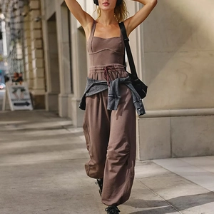 Detailed texture of dark coffee yoga jumpsuit featuring elastic drawstrings and joggers
