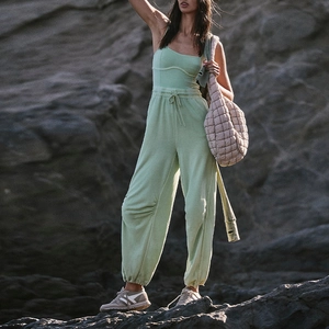 Detail of light green knit fitness set with spaghetti strap top and drawstring joggers