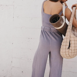 Rear view of purple-grey sports jumpsuit with drawstring waist and wide leg cut
