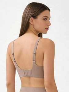 Detail view of pink seamless bra with adjustable straps and U-shaped back design