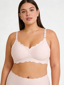 Detail of light pink seamless lingerie set with laser-cut scalloped edges and silk fabric