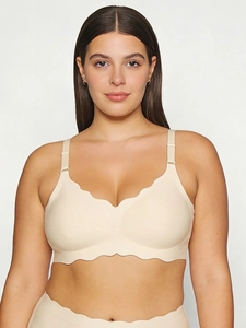 Detailed scalloped edge and adjustable strap on a beige seamless plus size bra