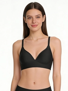 Seamless black wire-free bra with deep V-neckline and adjustable slim straps for daily comfort
