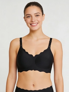 Detailed front view of black seamless wire-free bra with wave edge and adjustable straps