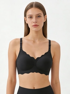 Detailed close-up of seamless black bra featuring distinctive wavy edges and smooth fabric