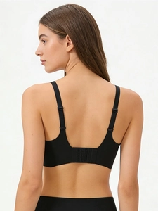 Rear view of black seamless plus-size bra featuring adjustable straps and hook-and-eye closure