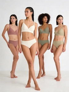 Detail of four models wearing seamless V-neck bras and matching panties in Morandi tones